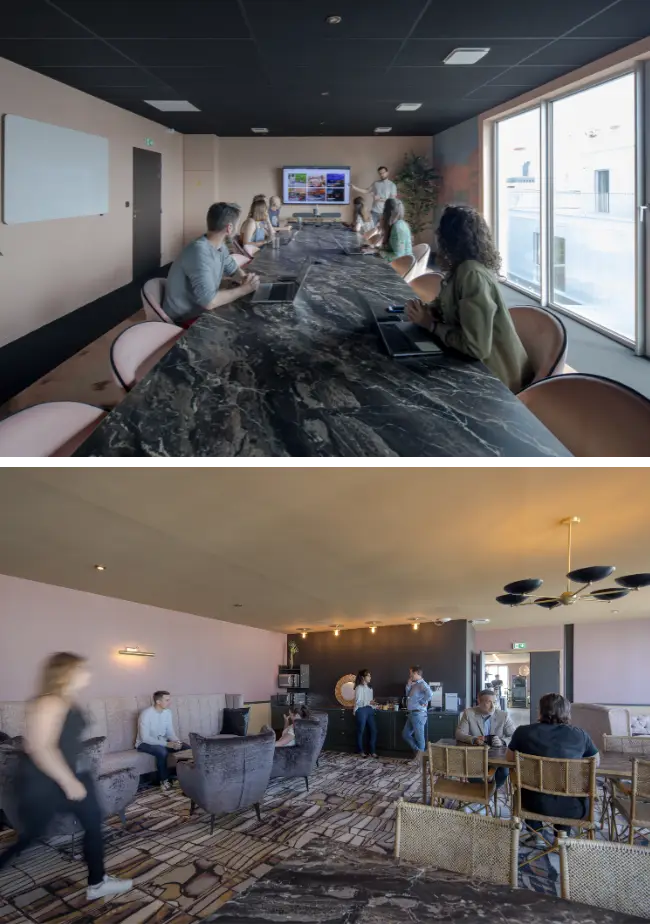 Coworkers réunis autour d’une grande table en marbre dans une salle élégante à Nantes.